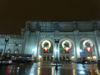 SAVE THE GRAY WOLF projected onto Union Station in Washington, DC.